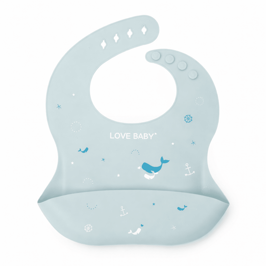 Bavoir bébé en silicone bleu avec poche récupératrice, décoré de motifs marins (baleines, ancres) et texte “Love Baby”, sur fond blanc