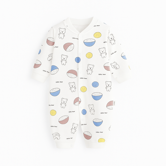 Combinaison bébé blanche ornée de petits oursons et bols colorés bleu, jaune et marron, ambiance douce et enfantine.