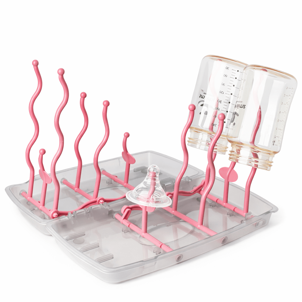 Égouttoir à biberon pliable rose avec deux biberons retournés et support pour tétine, design compact pour séchage hygiénique des accessoires bébé