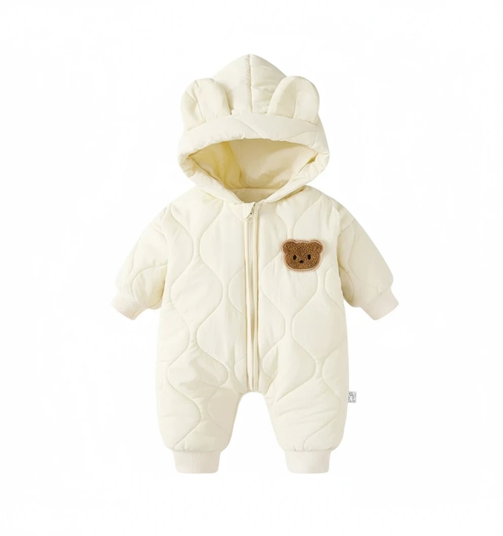 Combinaison d’hiver bébé crème avec capuche ourson et fermeture zippée.