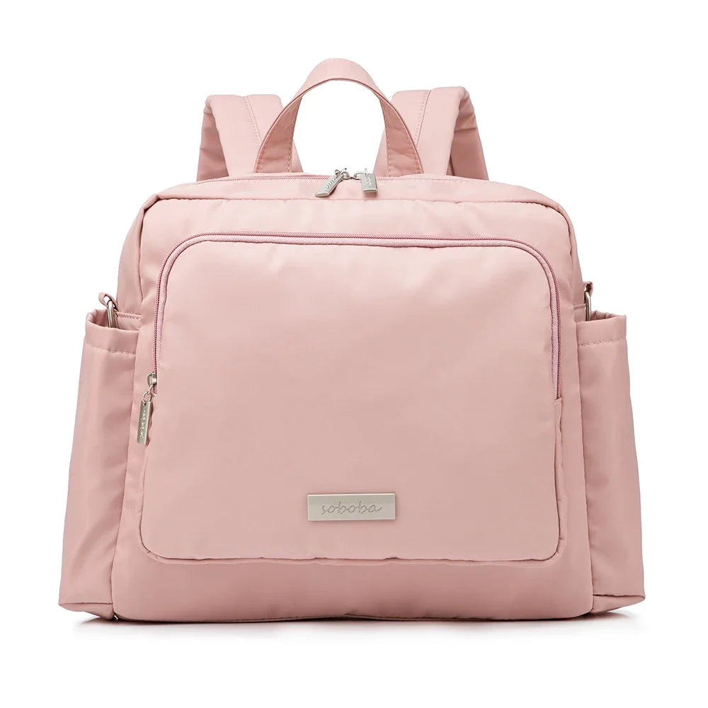 Sac à dos à langer rose poudré Kalinatur, modèle imperméable avec large poche frontale.