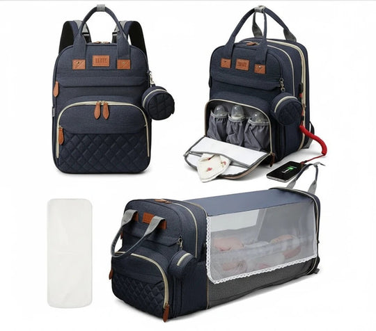 Sac à langer bleu marine avec compartiments isothermes et lit bébé pliable avec moustiquaire.
