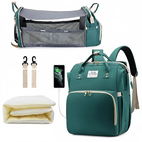 Sac à langer vert multifonction avec lit pliable, crochets poussette et matelas pour bébé.