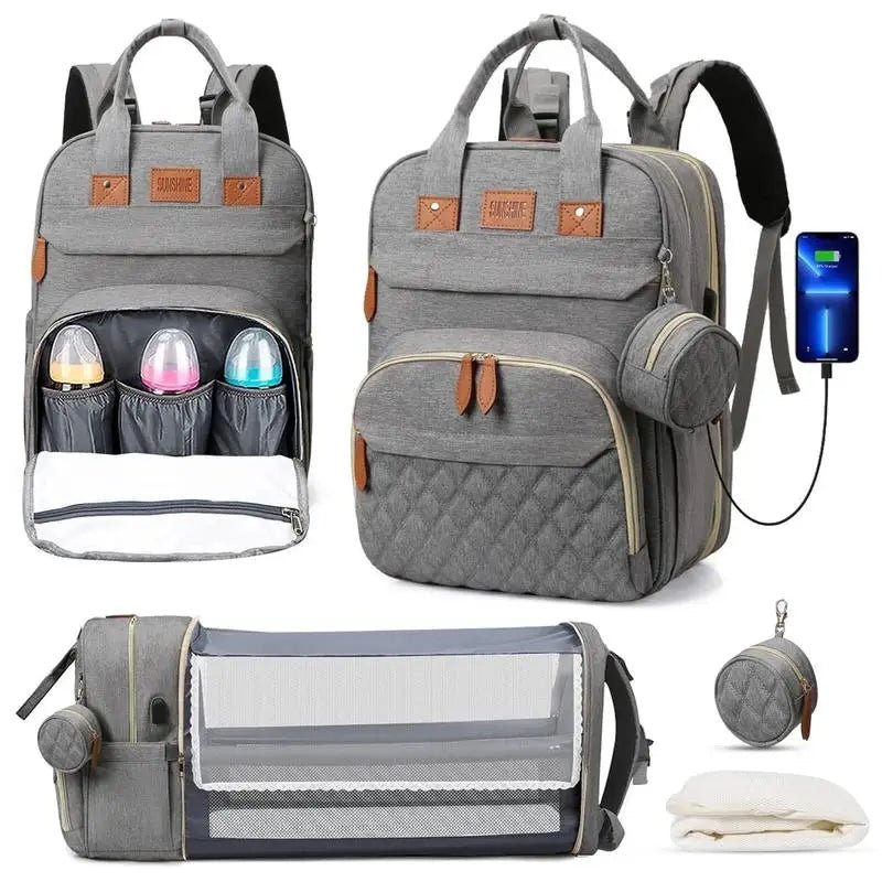 Sac à langer gris multifonction avec rangements isothermes, lit bébé pliable et accessoires inclus.