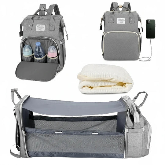Sac à langer gris clair avec poches isothermes et lit bébé pliable intégré.