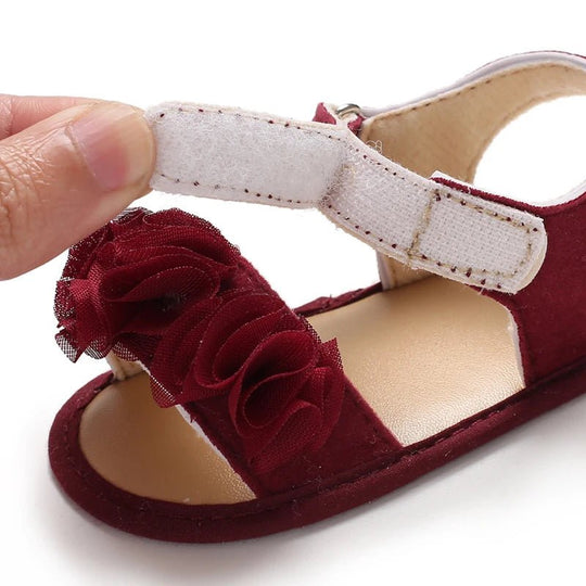 Détail sandales bébé fille rouges avec fleurs en tulle et fermeture scratch, chaussures premiers pas à semelle souple antidérapante pour bébé 0 à 18 mois
